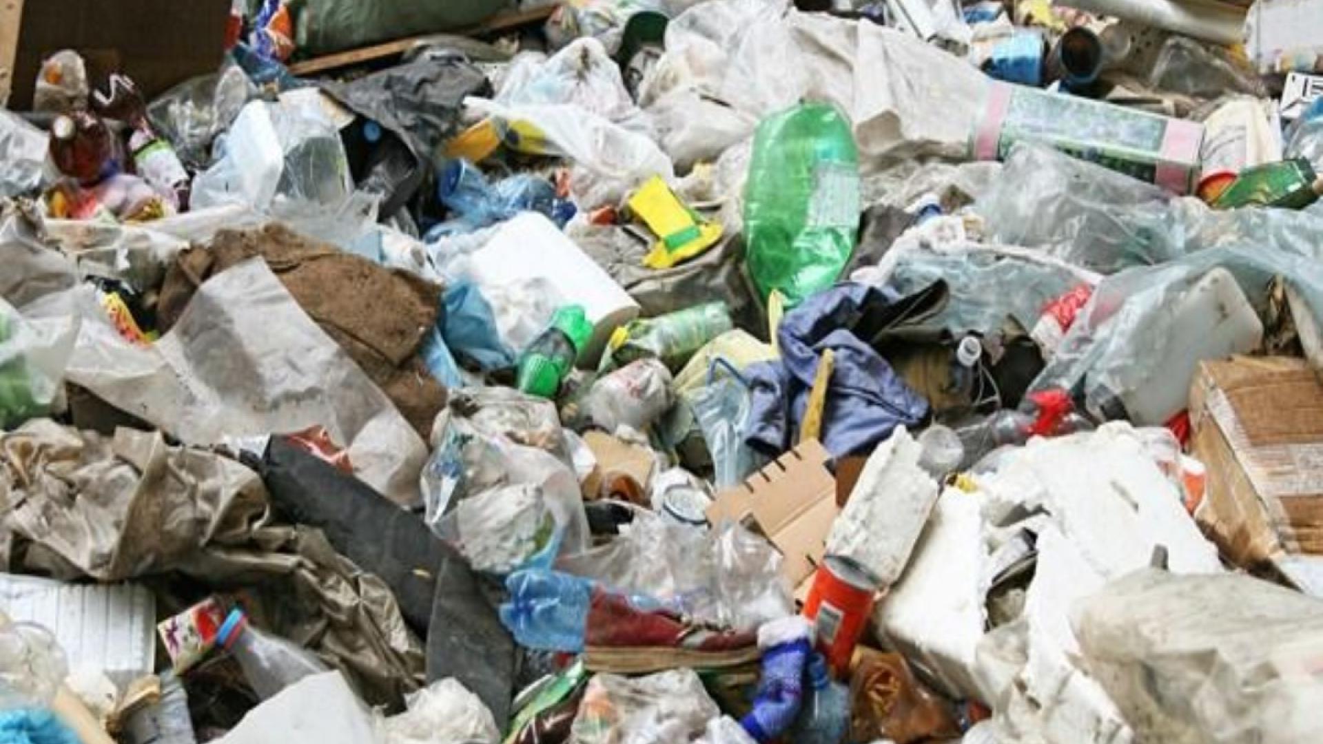 Piles of mixed garbage, including plastic bottles and papers.