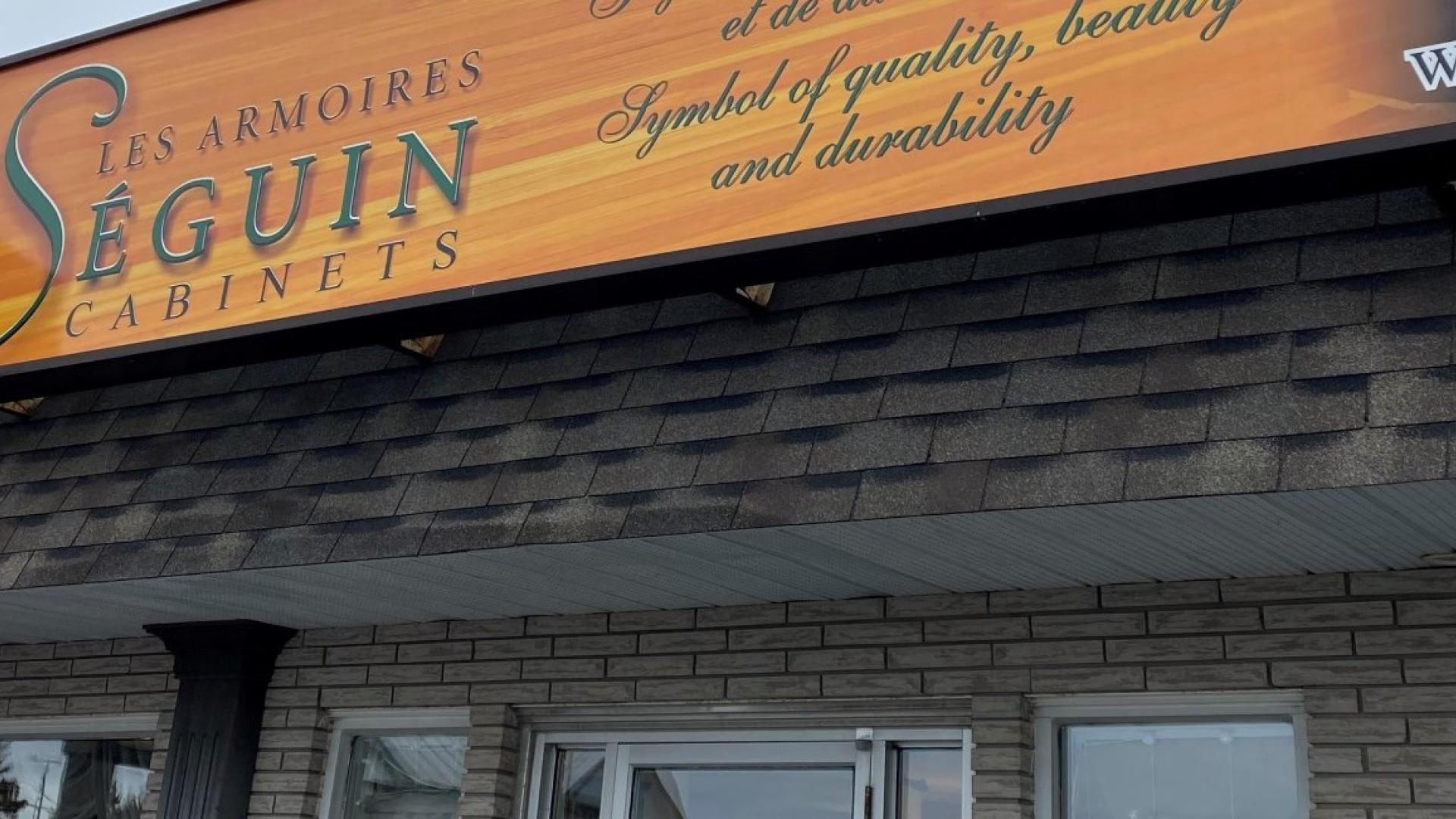 Building with a sign reading "Seguin Antiques" on a cloudy day.