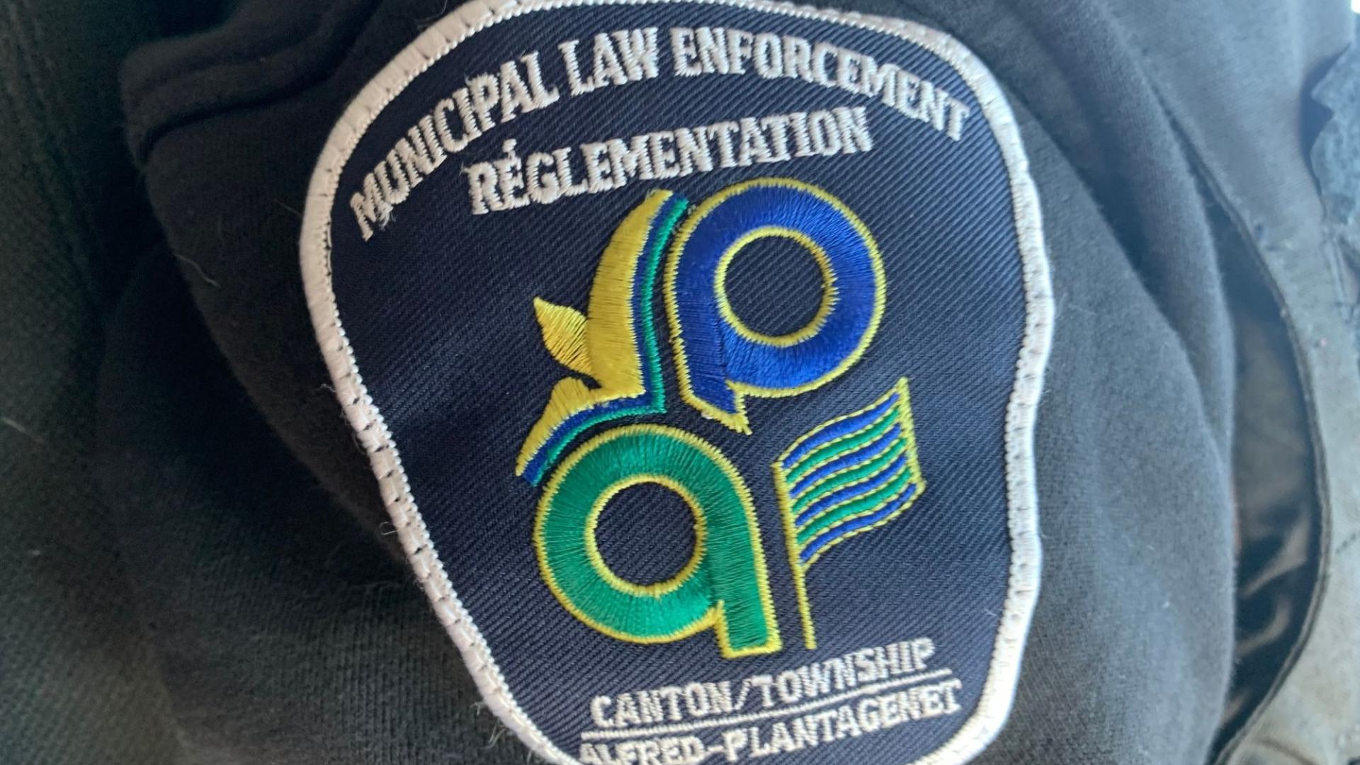 Municipal law enforcement patch on dark fabric.