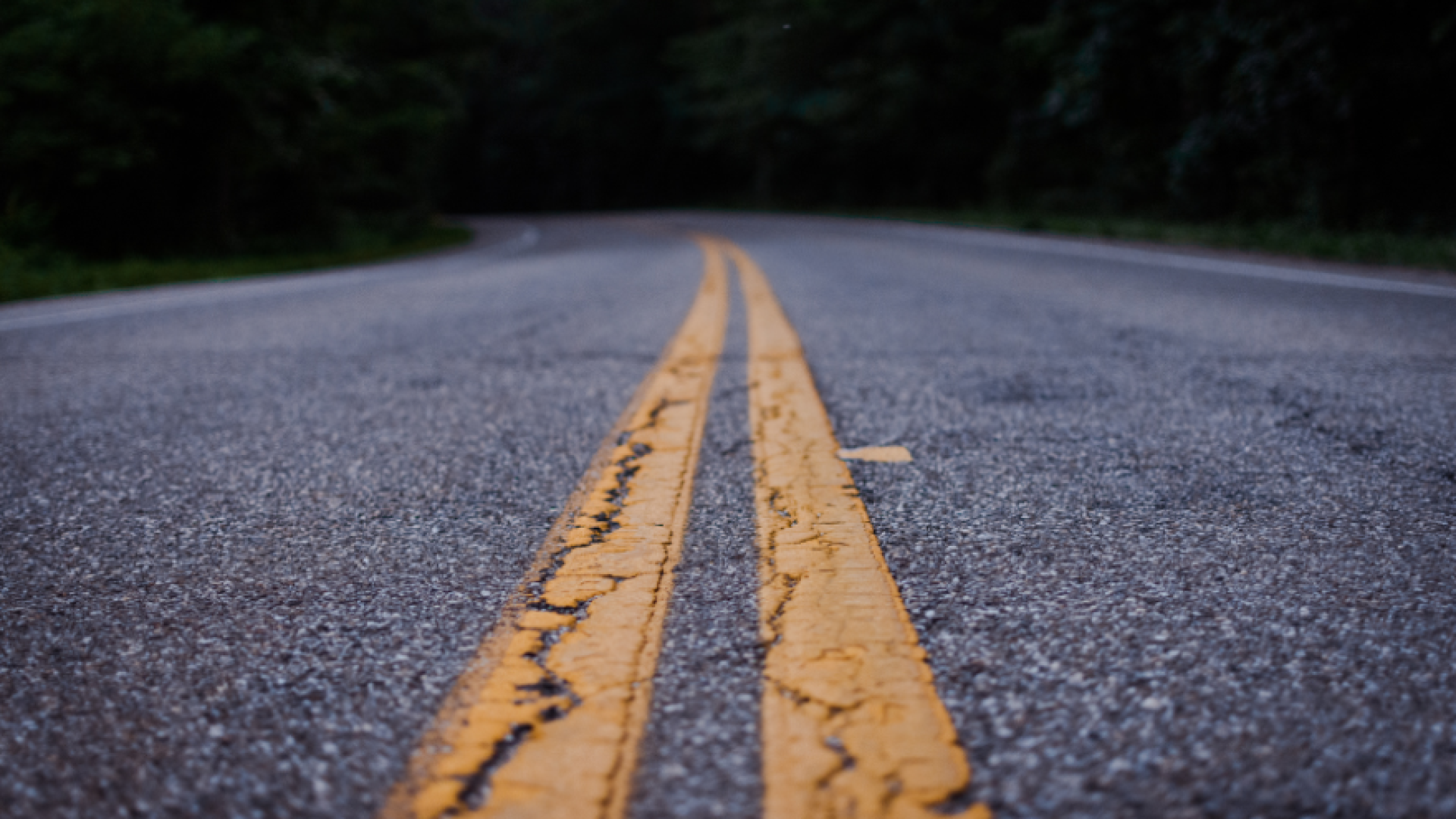 Close up of a paved road and it's median lines