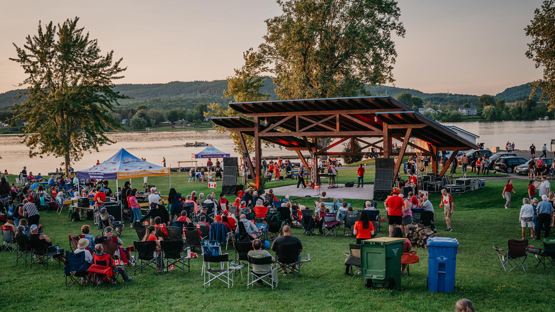 Outdoor scene with about a hundred people watching it