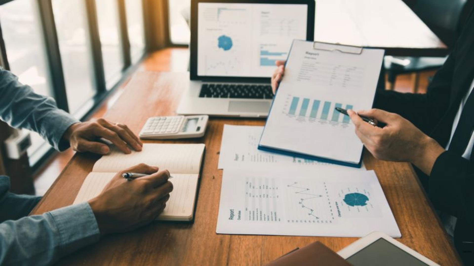 Office workers sharing reports with eachother.