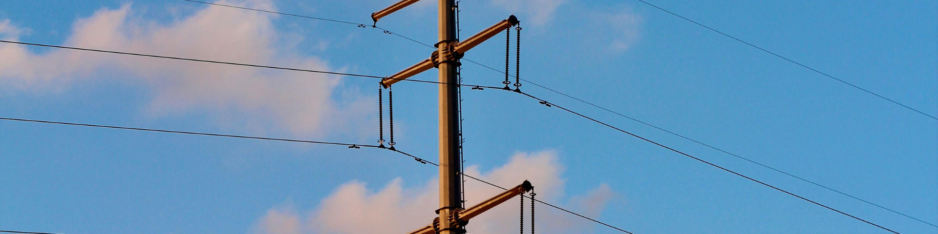 Overhead power line with blue skies in the background