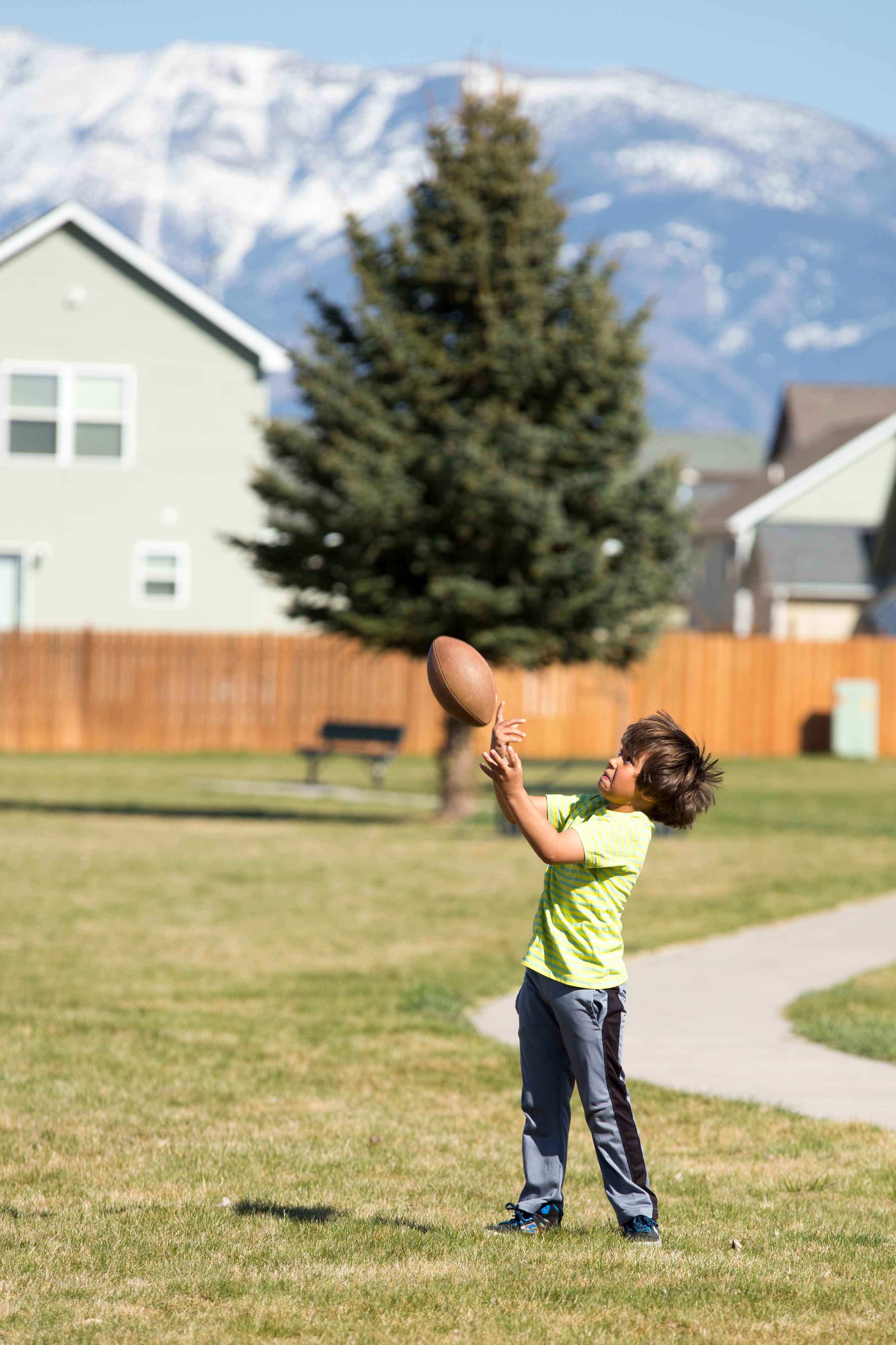 A child with a football in the air
