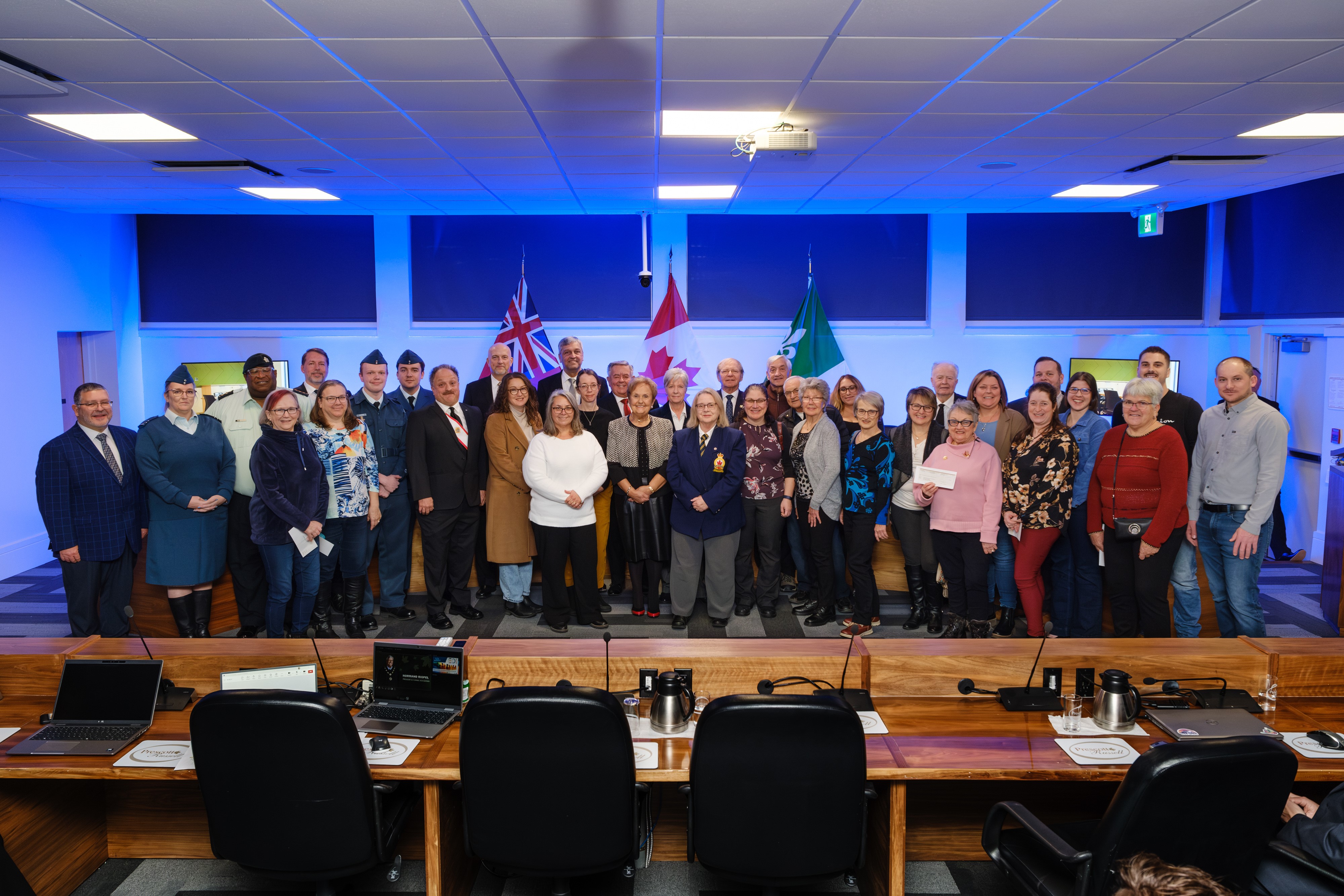 Outgoing Warden Mr. Normand Riopel posing with Warden Yves Laviolette and the representatives of 24 regional community organizations 