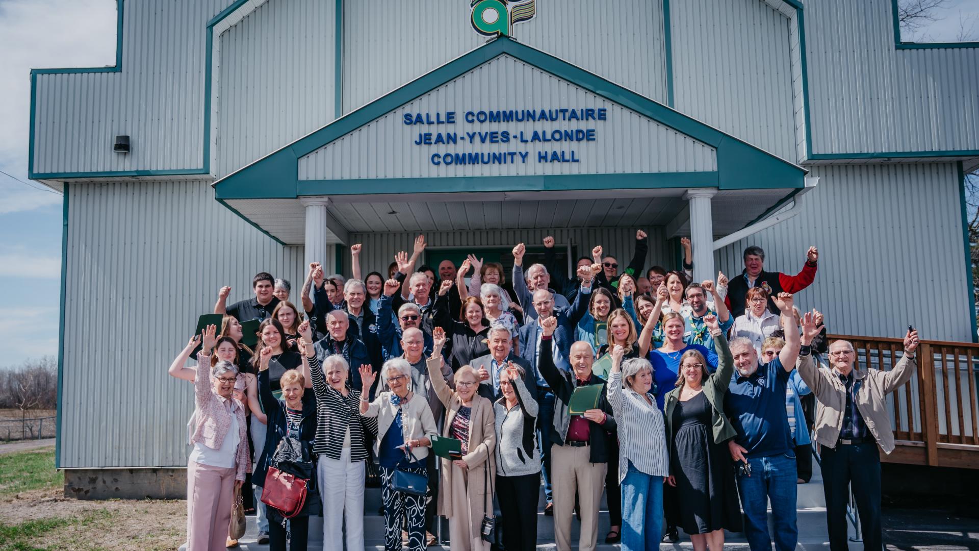 Volunteers and Jean-Yves Lalonde's outside the Jean-Yves-Lalonde Community Hall