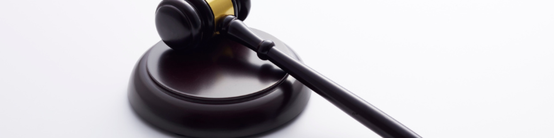 Black and gold gavel on a white background