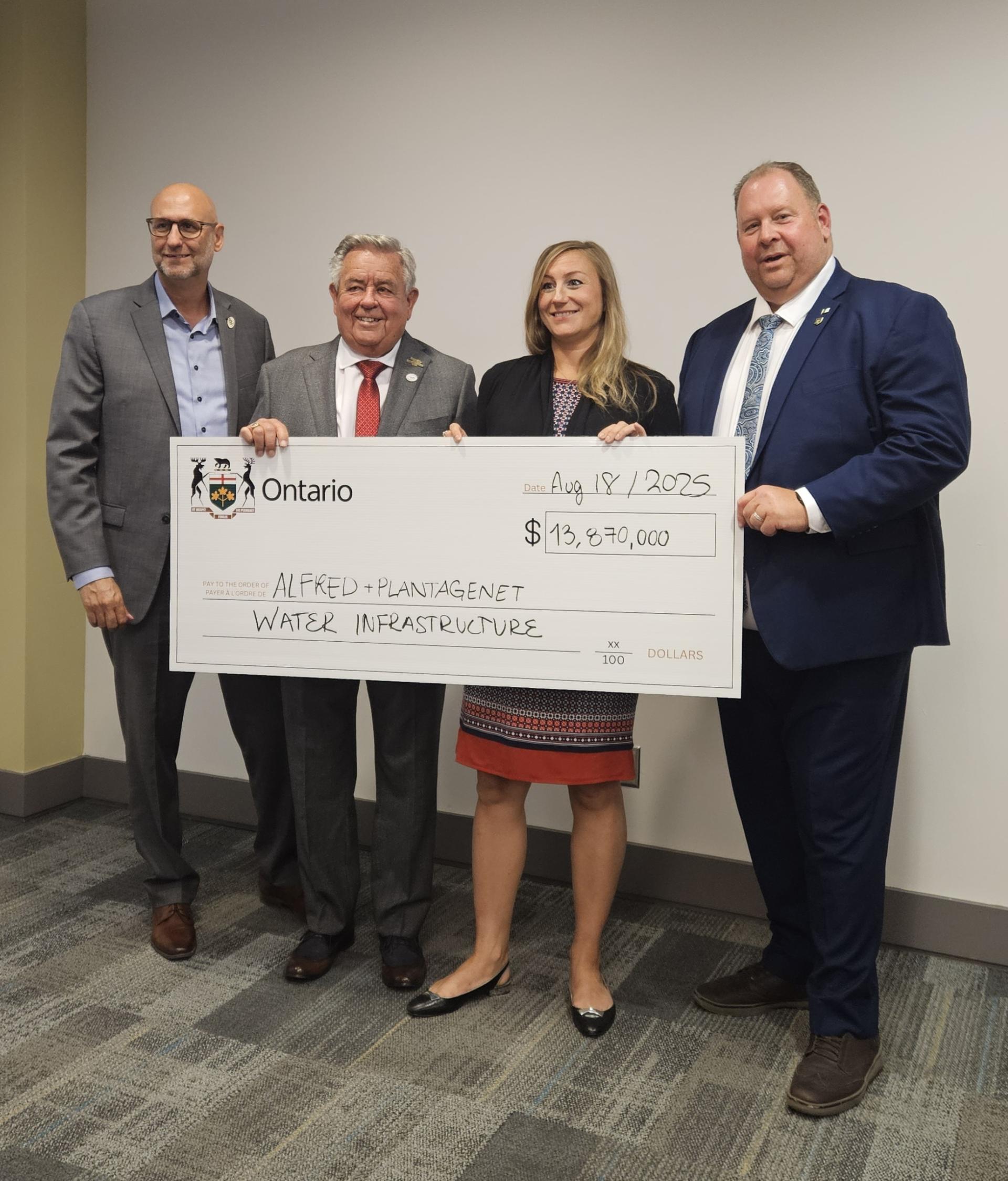 Michel Potvin, Chief Administrative Officer of the Township of Alfred and Plantagenet, Yves Laviolette, Mayor of the Township of Alfred and Plantagenet, the Honourable Kinga Surma, Ontario Minister of Infrastructure, and Stéphane Sarrazin, MPP for Glengarry–Prescott–Russell, holding the cheque for the lagoon expansion.